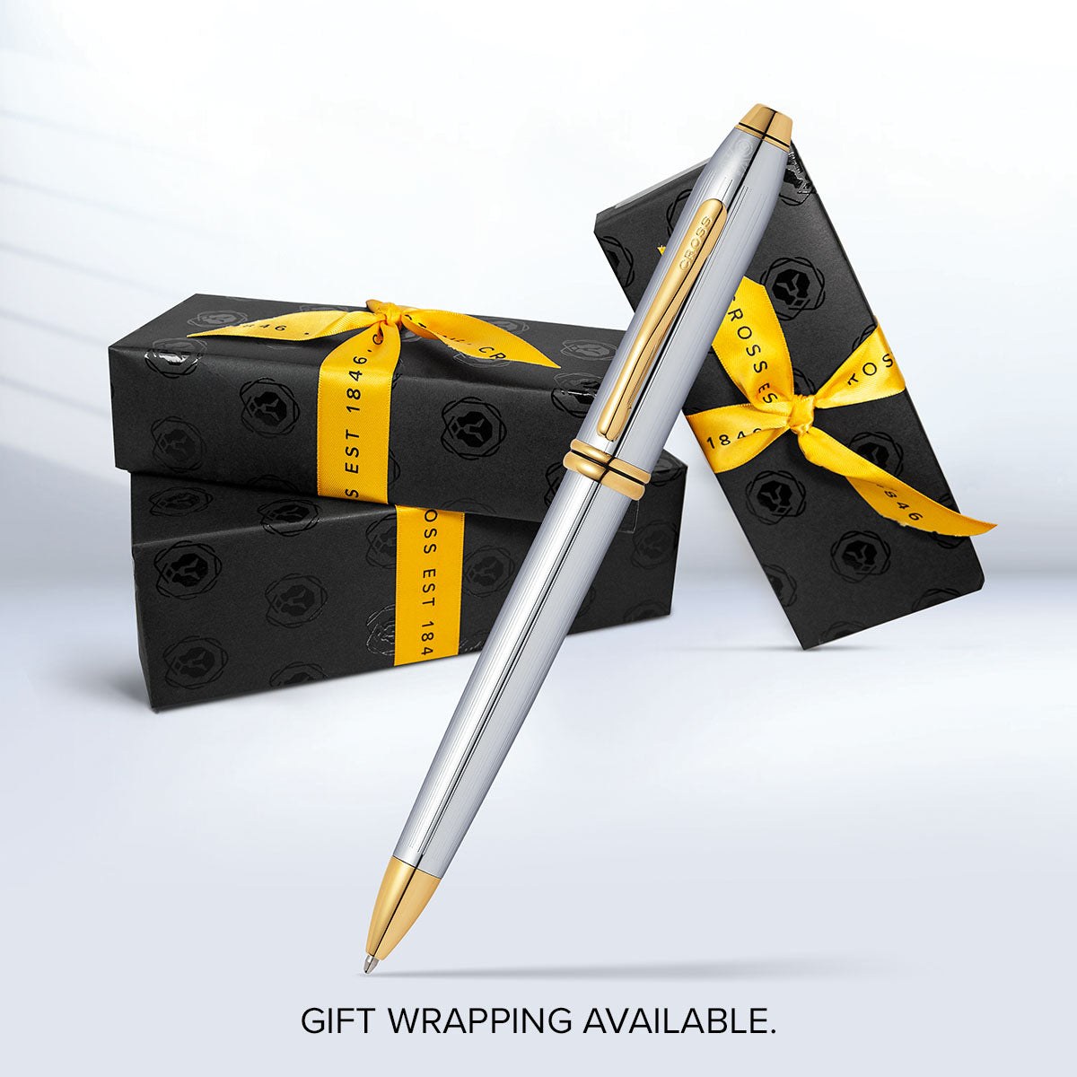 Townsend Medalist Ballpoint Pen by A.T. Cross; silver body with gold trim beside gift boxes on Tampa Home & Garden Store