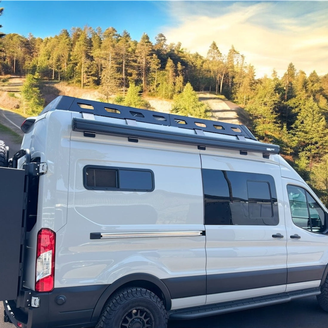 Avatar Ford Transit Rockbody side steps on a white van with roof rack, rugged offroad accessory on Tampa Home & Garden Store