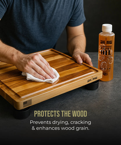 Premium Walnut Cutting Board Oil bottle by The True Board beside a striped wooden cutting board on Tampa Home & Garden Store