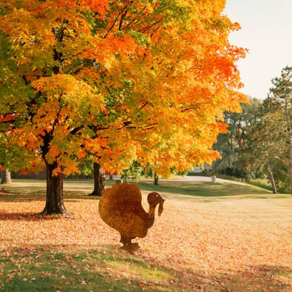 Rusty metal turkey lawn ornament in autumn park with orange maple leaves on Tampa Home & Garden Store