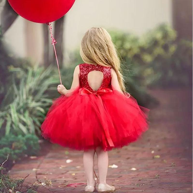 Baby girl red sequin sleeveless dress with tutu back keyhole holding red balloon on Tampa Home & Garden Store