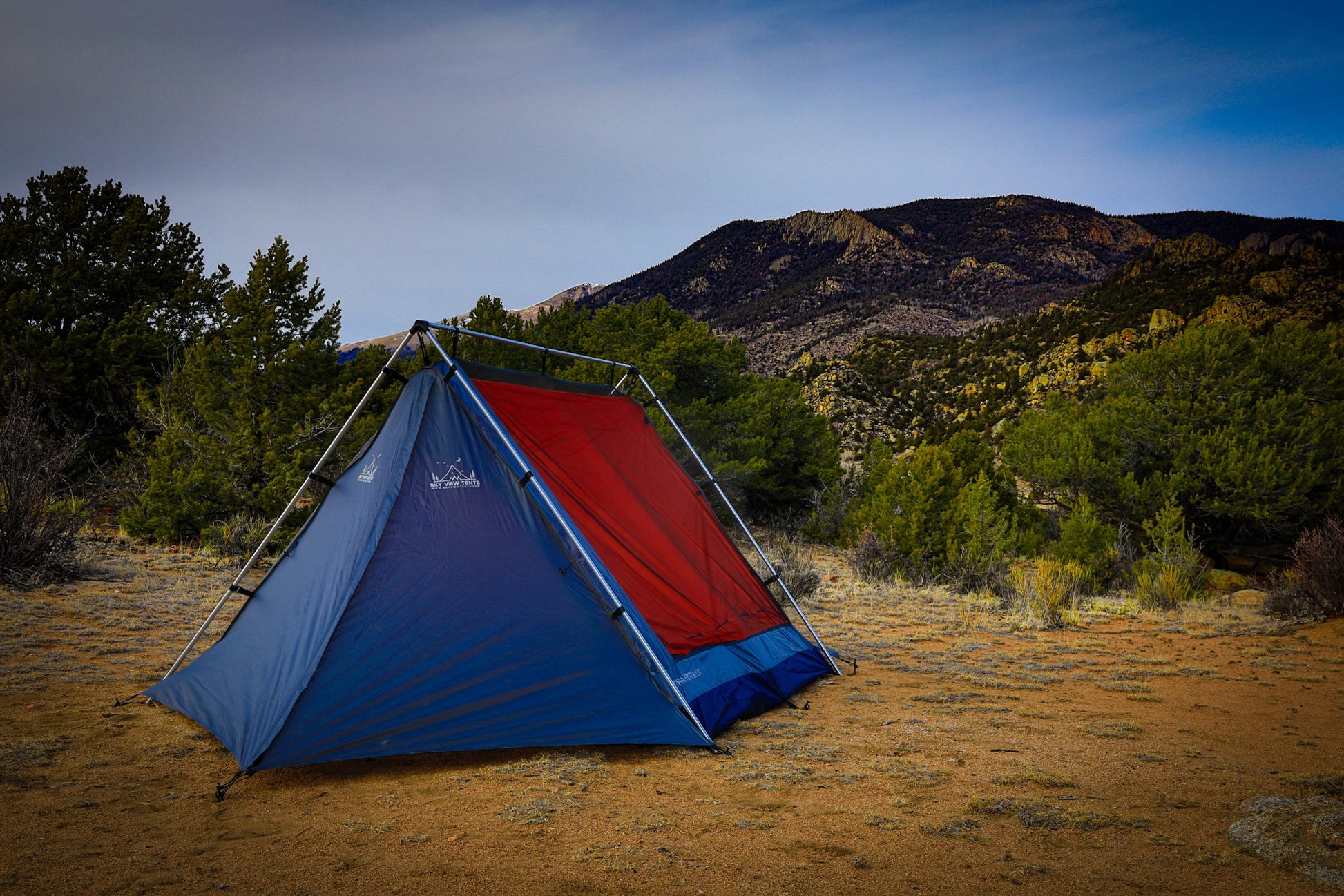 Sky View XL Tent blue and red with metal frame in a desert landscape by Sky View Tents on Tampa Home & Garden Store