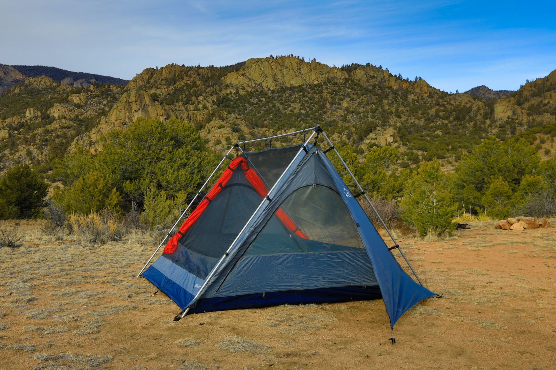 Sky View XL Tent blue-gray with red accents and aluminum frame on rocky desert landscape on Tampa Home & Garden Store