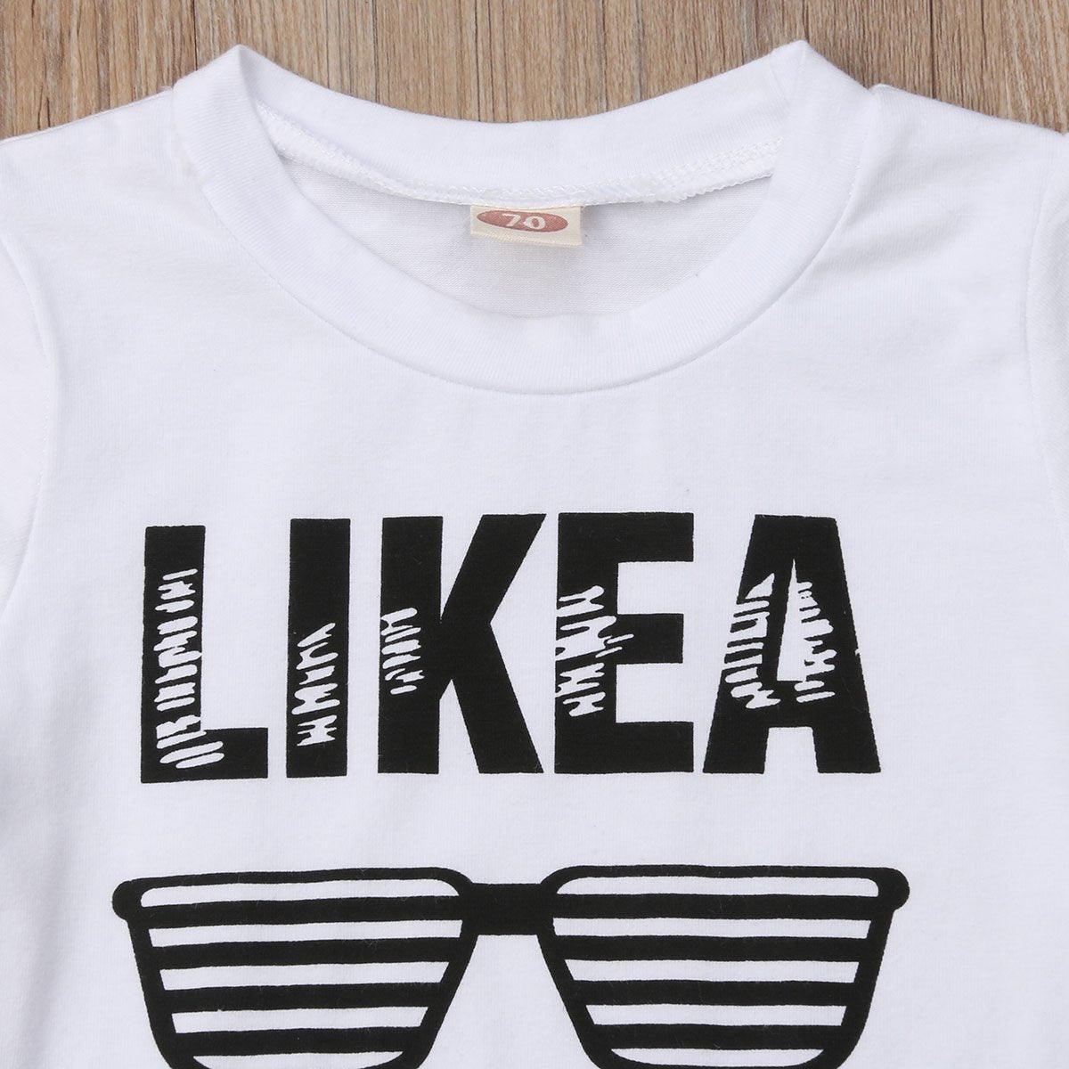 White toddler short sleeve tee with bold LIKE A graphic and striped sunglasses print on Tampa Home & Garden Store
