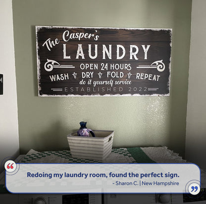 Personalized laundry room sign canvas with dark wood backdrop and white distressed lettering on Tampa Home & Garden Store
