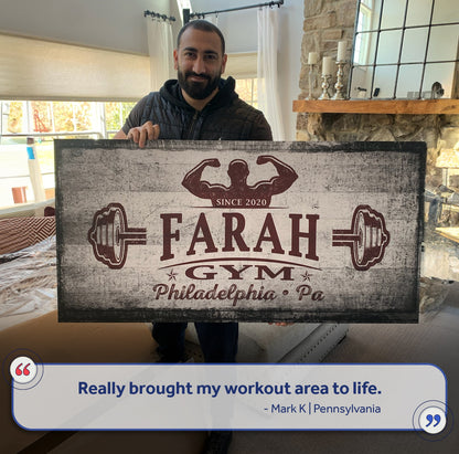 Gym Sign VI canvas with distressed gray texture and red flexed-arm logo, large sign held by man on Tampa Home & Garden Store