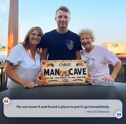 Man Cave Sign IV canvas by Tailored Canvases; wood plaque CHRIS' MAN CAVE held by three smiling adults on Tampa Home & Garden Store