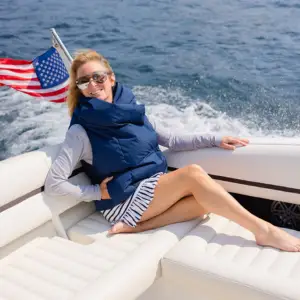 Pretty Rugged Waterproof Puffer Vest worn by a woman on a boat, blue outerwear on Tampa Home & Garden Store
