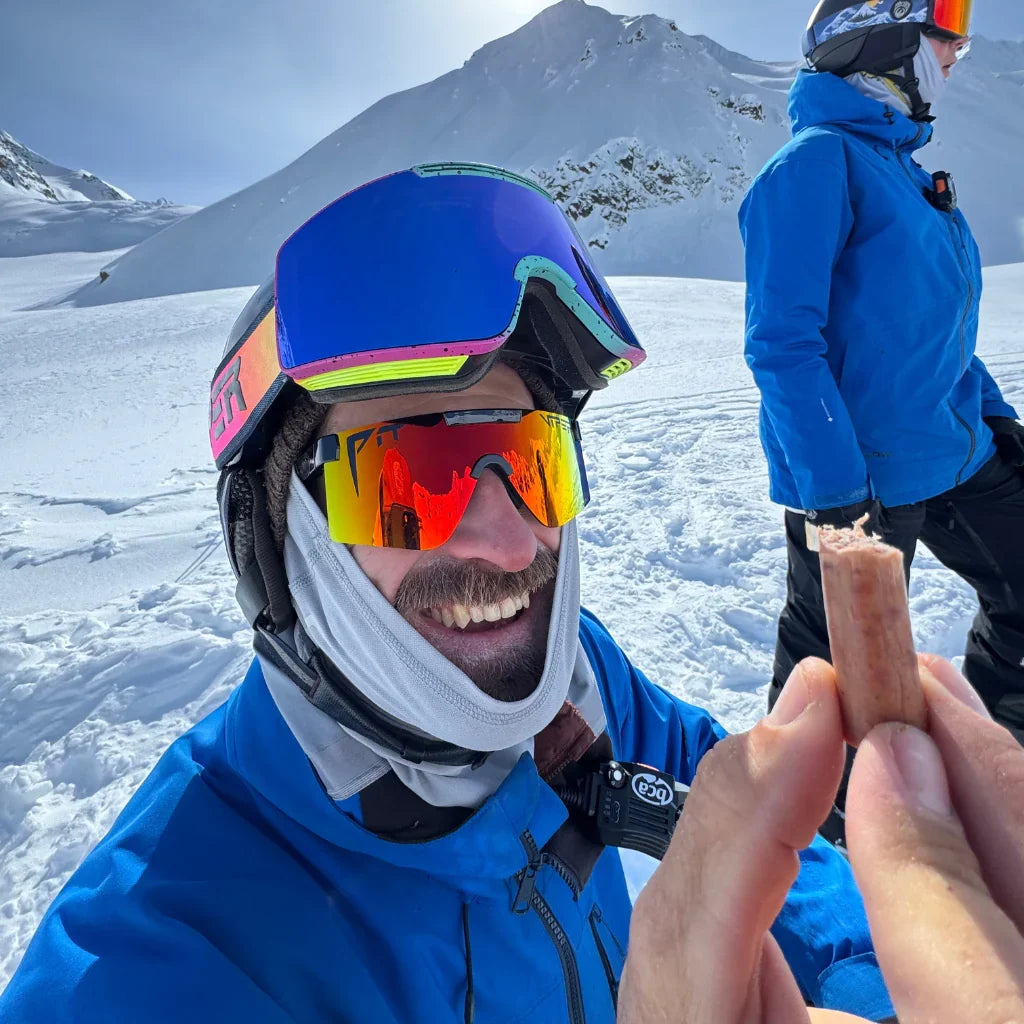 Pit Viper sunglasses UV400 with orange mirrored lenses worn by person in blue jacket on a snowy mountain on Tampa Home & Garden Store