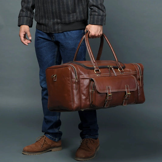 Buffalo Leather Traveler Weekender Duffle brown with brass hardware carried in blue jeans on Tampa Home & Garden Store