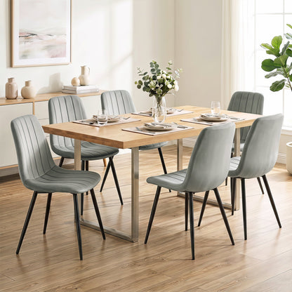 Upholstered dining chairs set of 4 with metal legs in light gray fabric around a wooden dining table on Tampa Home & Garden Store