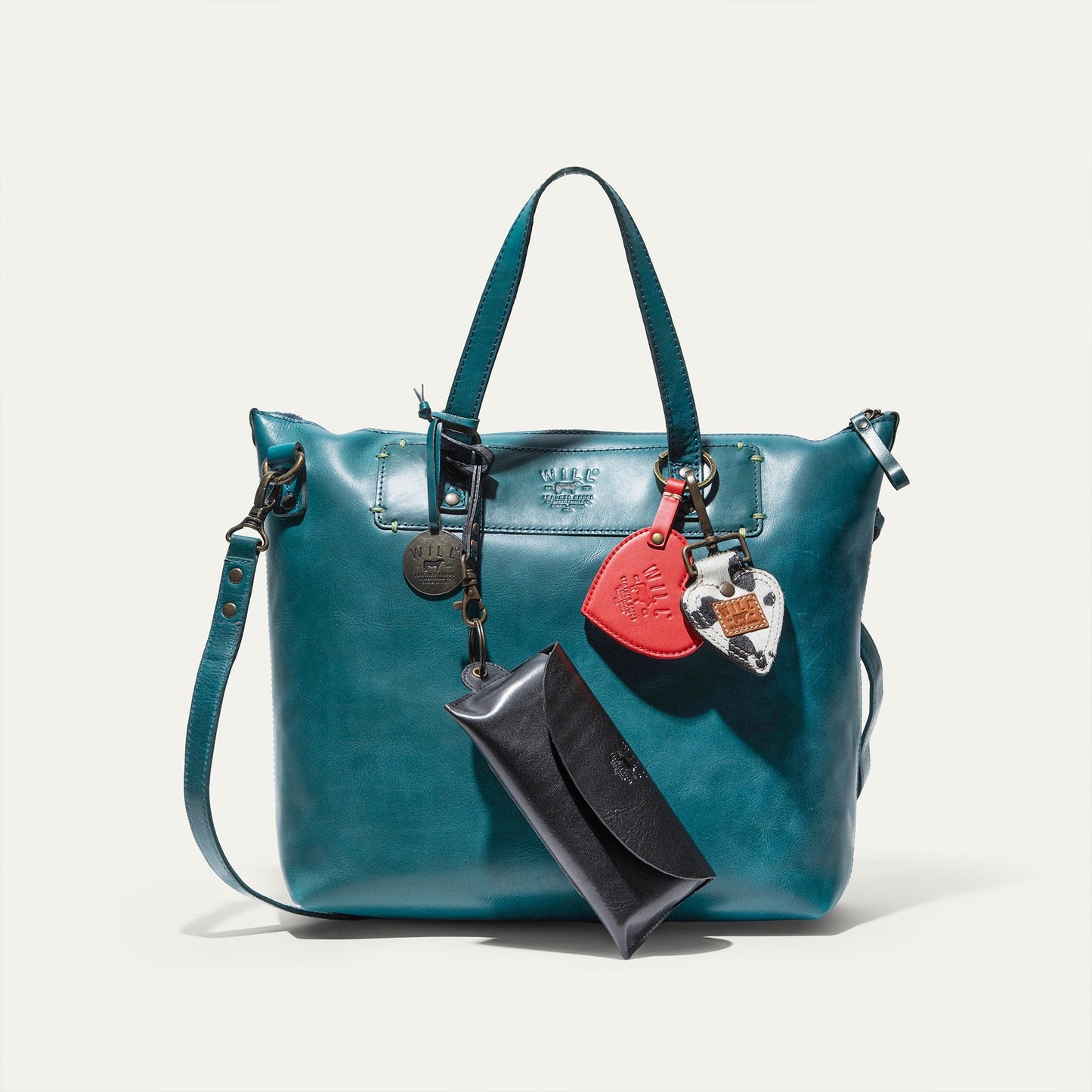 Will Leather Goods Simple Satchel teal leather bag with top handles and decorative tags on Tampa Home & Garden Store
