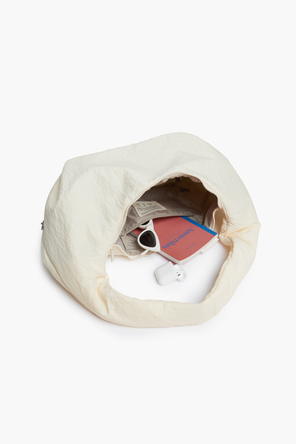 Myra Bag Ivory Shoulder Bag with Circular Handle by Lefrik USA, open to show sunglasses on Tampa Home & Garden Store