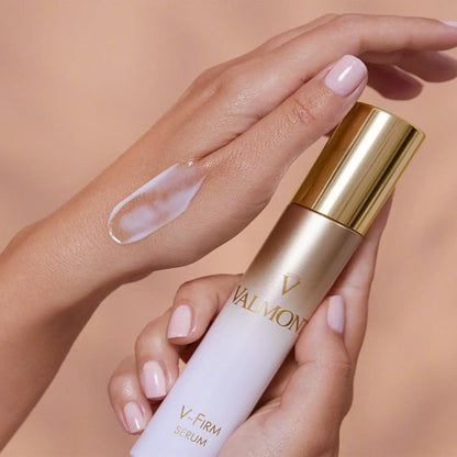 Valmont V-Firm Serum 30ml bottle with gold cap, cream applied on the back of the hand on Tampa Home & Garden Store