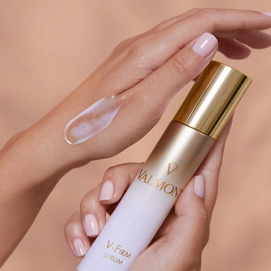 Valmont V-Firm Serum 30ml bottle with gold cap, cream applied on the back of the hand on Tampa Home & Garden Store