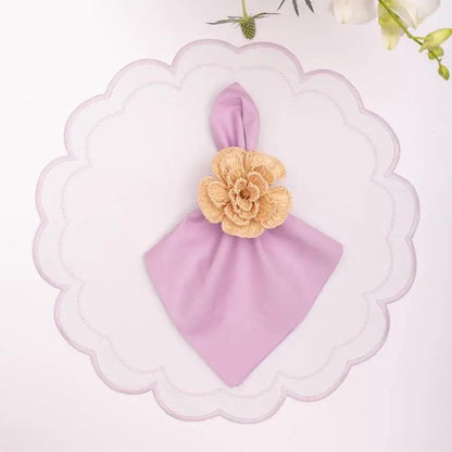 Solid lavender cotton napkin with beige crochet flower accent on a scalloped white plate on Tampa Home & Garden Store
