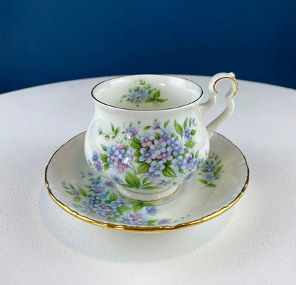 Teacup and saucer with vintage forget-me-not blue floral pattern, white porcelain, gold trim on Tampa Home & Garden Store