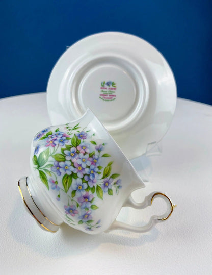 Teacup and saucer with Forget-Me-Not blue floral pattern on white porcelain with gold trim on Tampa Home & Garden Store