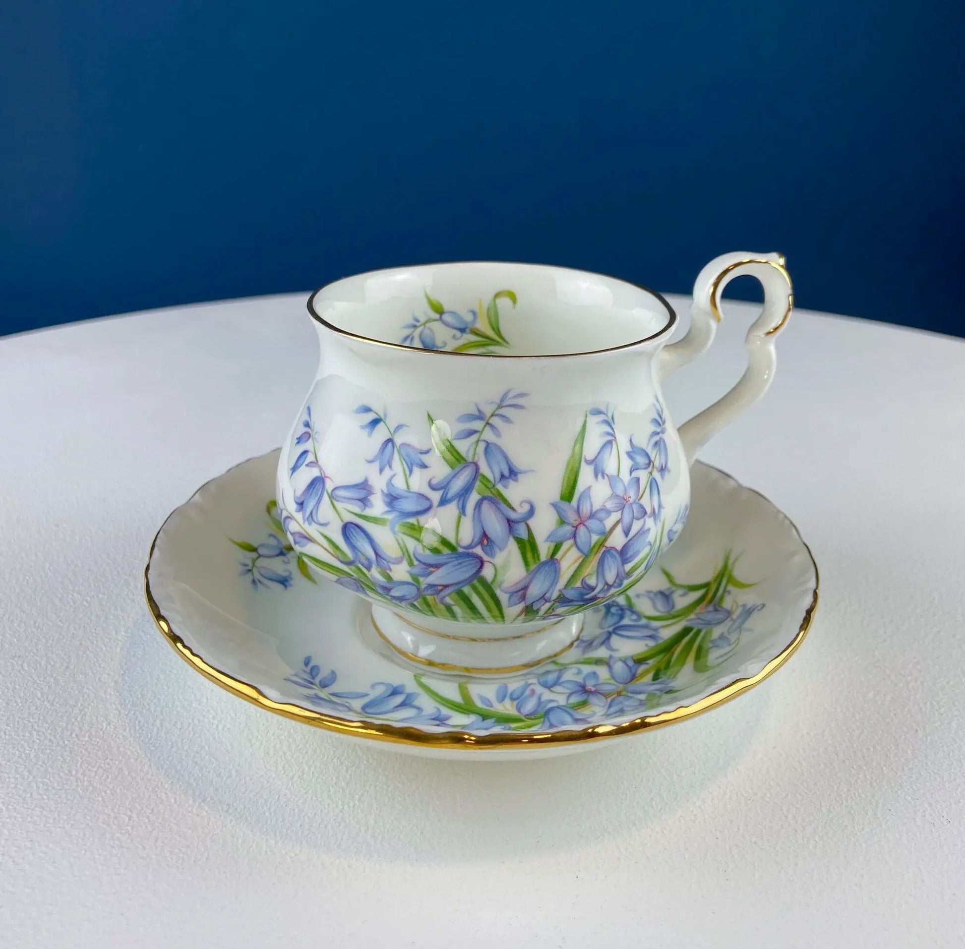 Vintage Forget-Me-Not teacup and saucer with blue floral pattern and gold trim on porcelain on Tampa Home & Garden Store