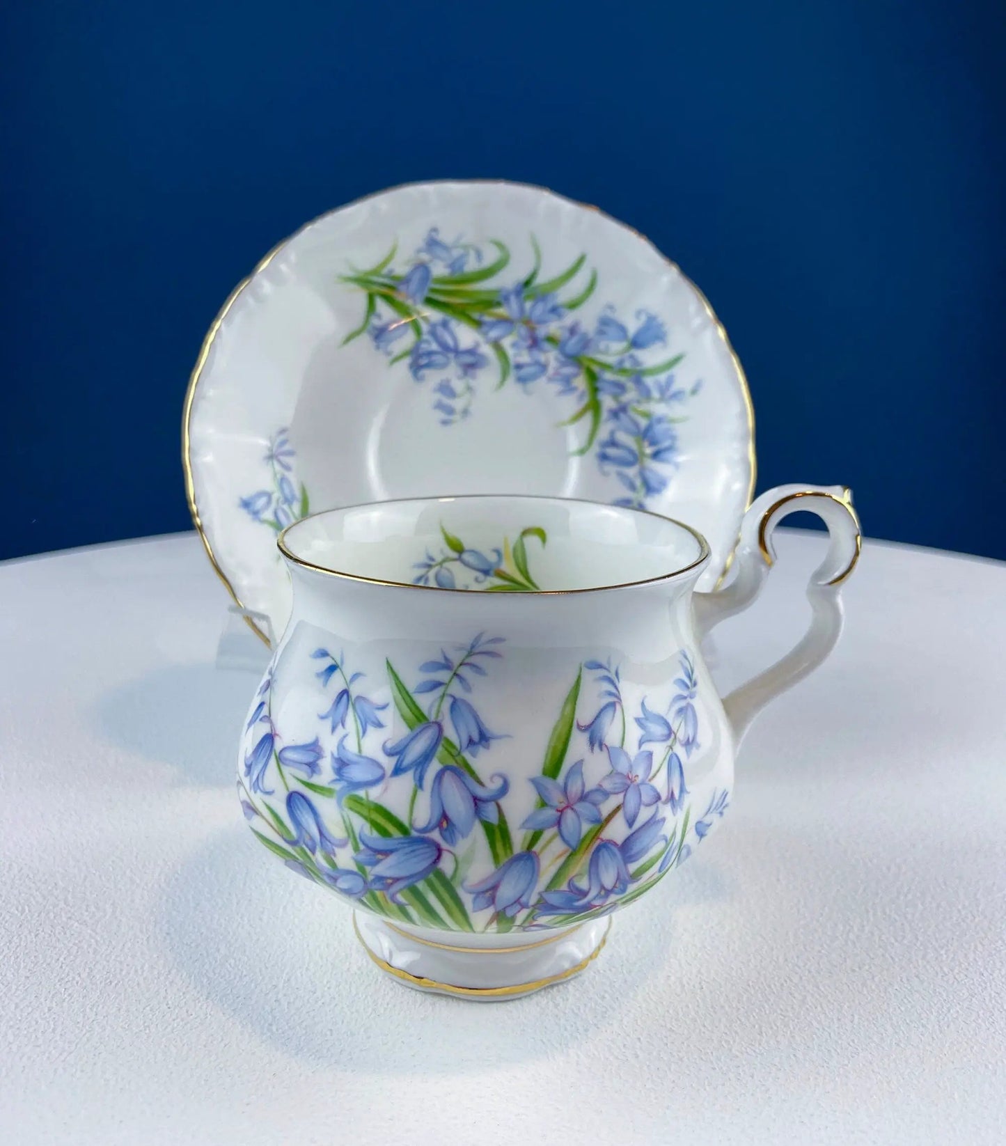 Vintage Forget-Me-Not teacup and saucer with blue floral pattern and gold trim on Tampa Home & Garden Store