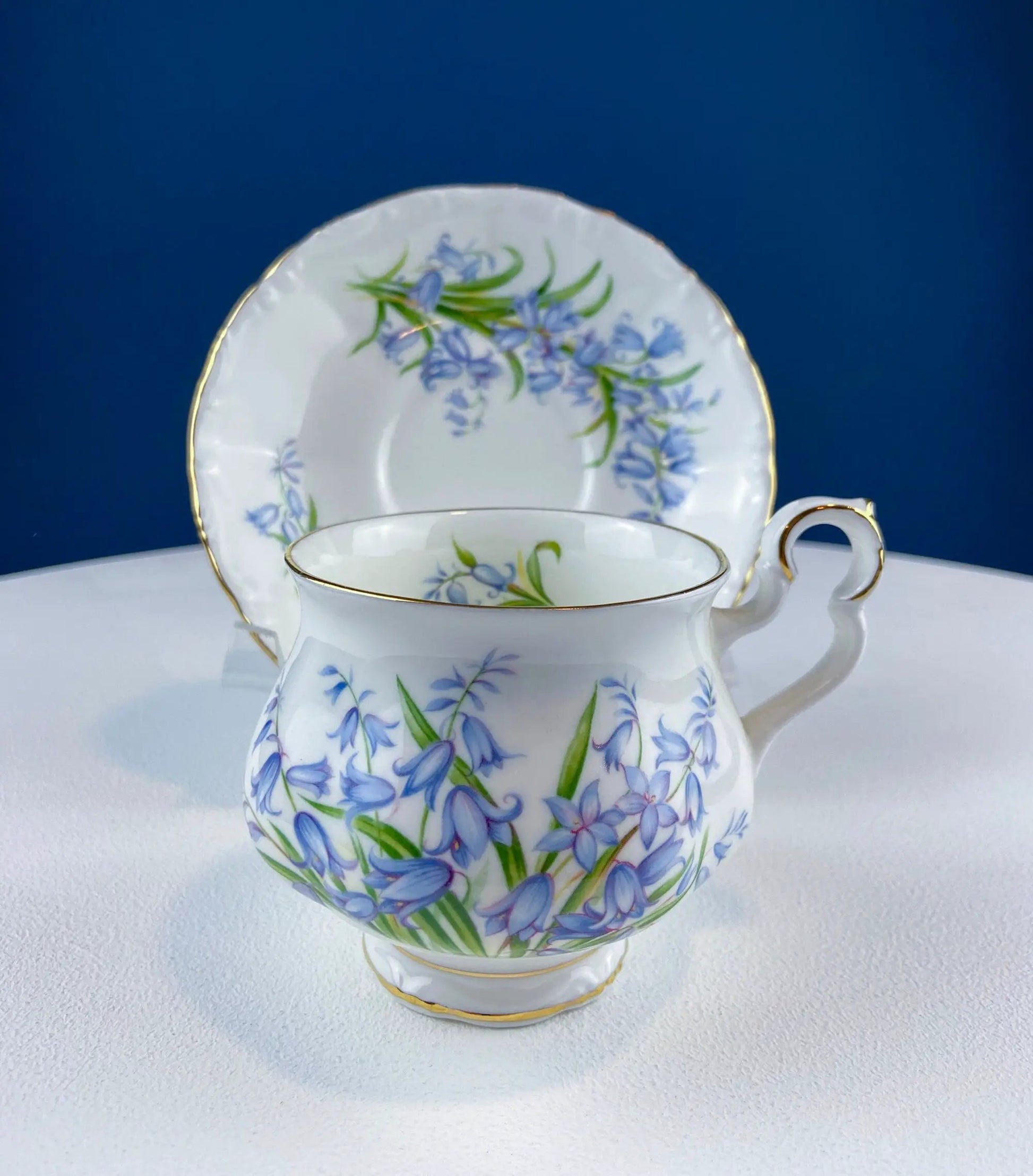 Vintage Forget-Me-Not teacup and saucer with blue floral pattern and gold trim on Tampa Home & Garden Store