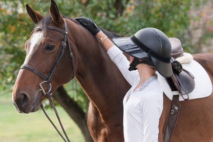 EquiVisor® Sport Vue Complete 4.5in sun visor on black glossy riding helmet worn by rider on Tampa Home & Garden Store