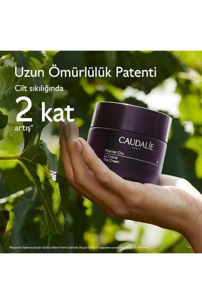 Caudalie Premier Cru The Cream face cream in a dark purple jar held in hand on Tampa Home & Garden Store