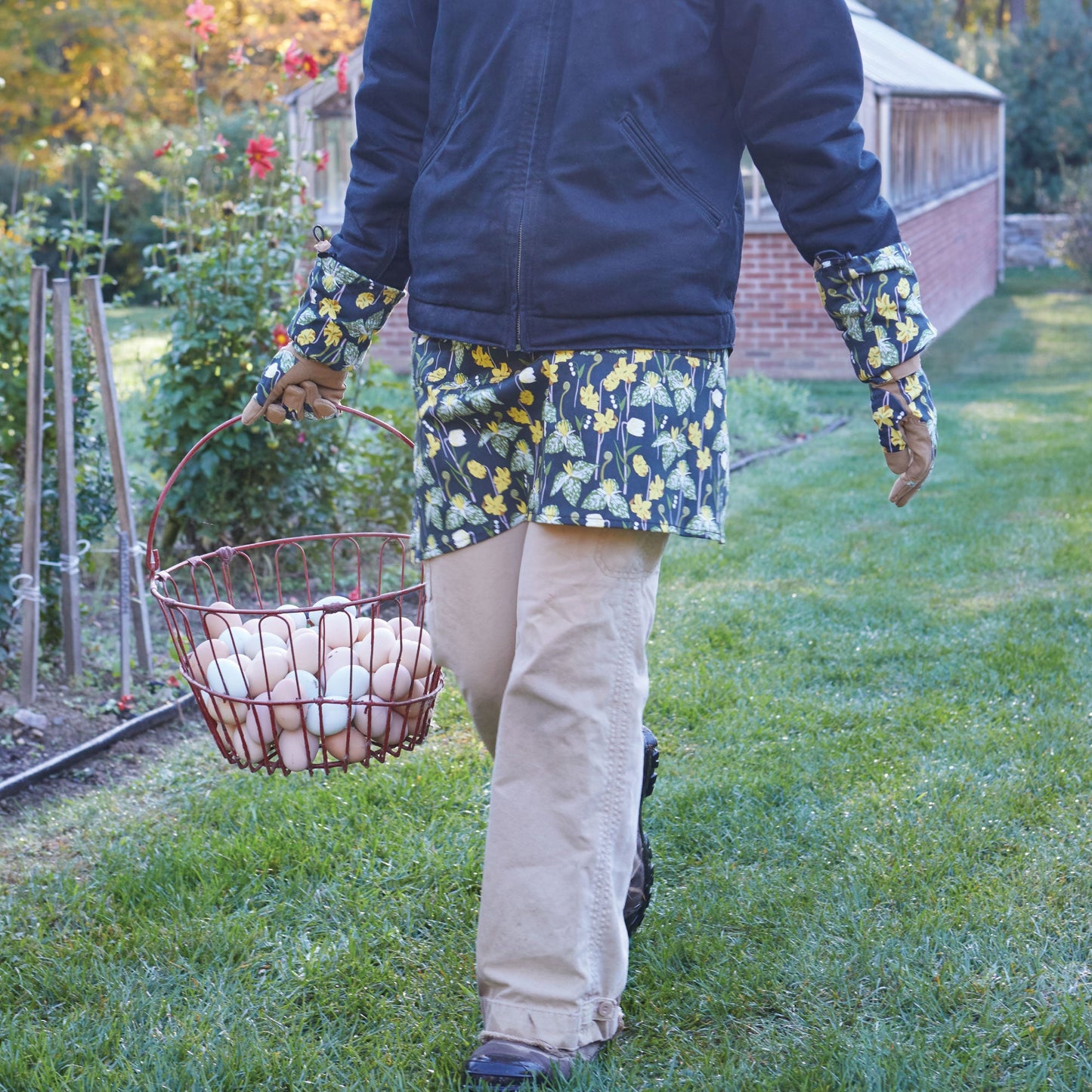 Gardener's Half Apron by Womanswork, worn by gardener outdoors with egg basket on Tampa Home & Garden Store