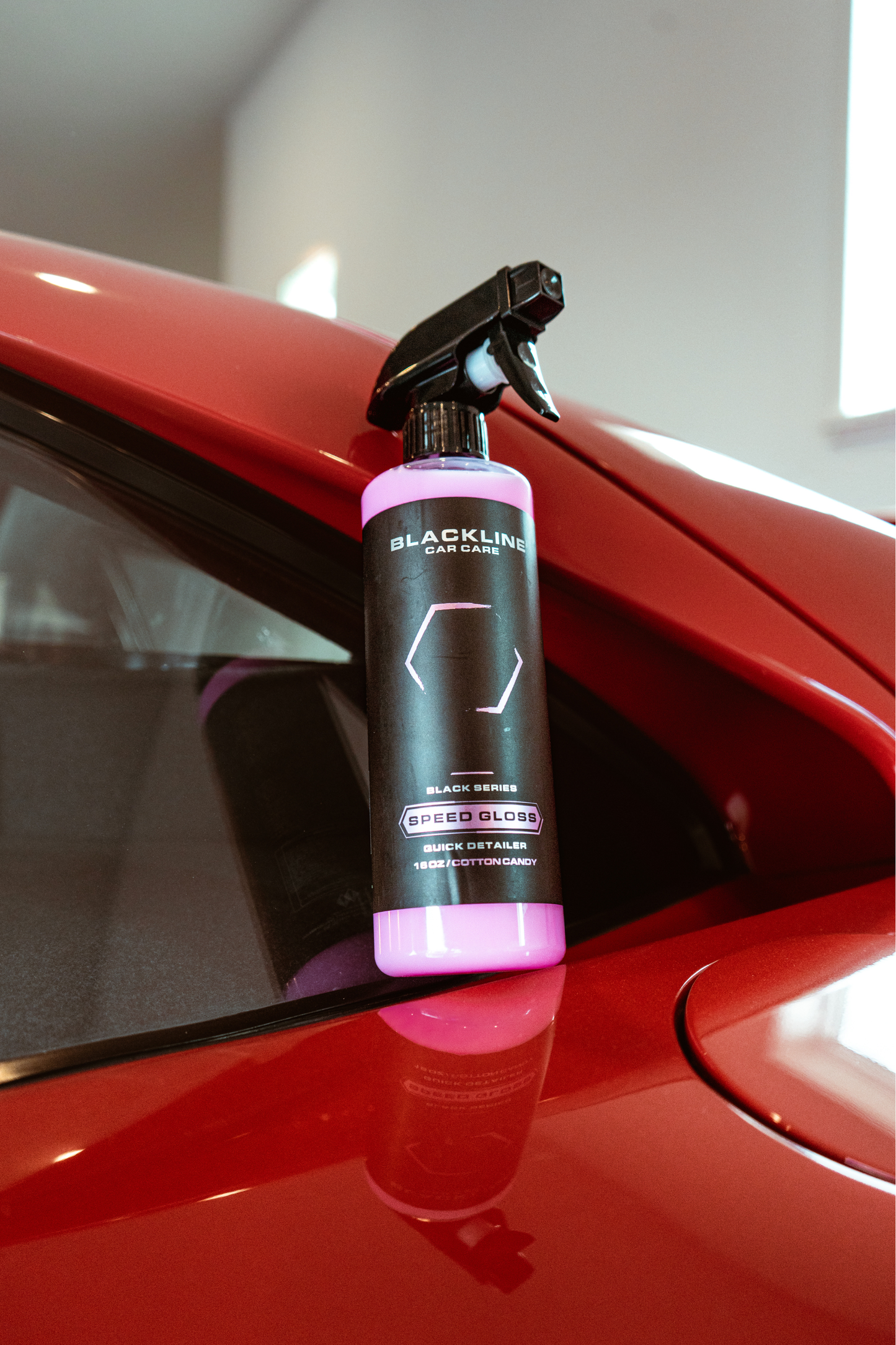 BLACKLINE SPEED GLOSS QUICK DETAILER bottle with pink liquid on red car hood by Blackline on Tampa Home & Garden Store