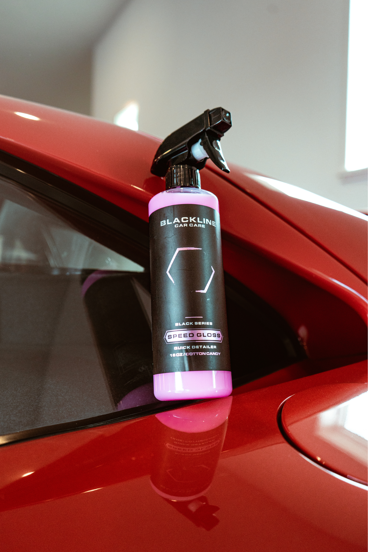 BLACKLINE SPEED GLOSS QUICK DETAILER bottle with pink liquid on red car hood by Blackline on Tampa Home & Garden Store