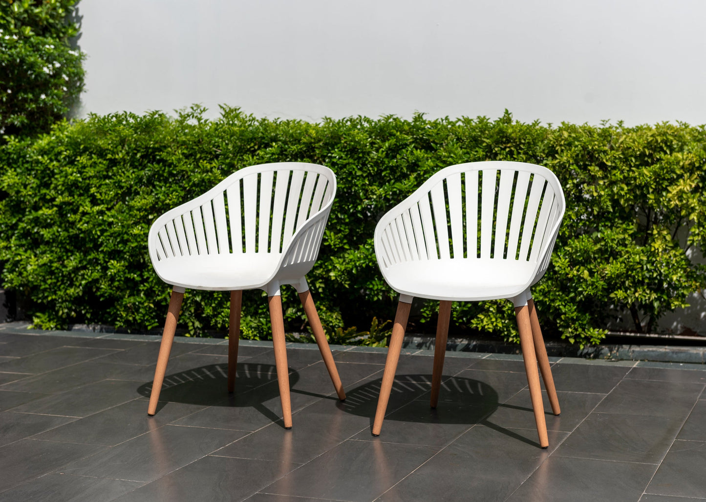Leyland Table and Nassau White Armchairs Dining Set white armchairs with wooden legs on patio on Tampa Home & Garden Store