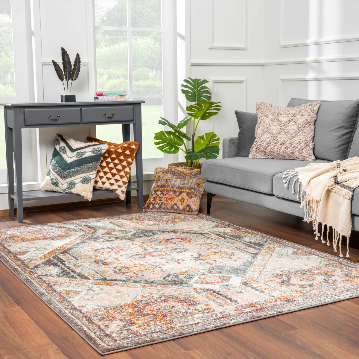 Woorabinda Area Rug gray distressed geometric print with orange teal accents in living room on Tampa Home & Garden Store