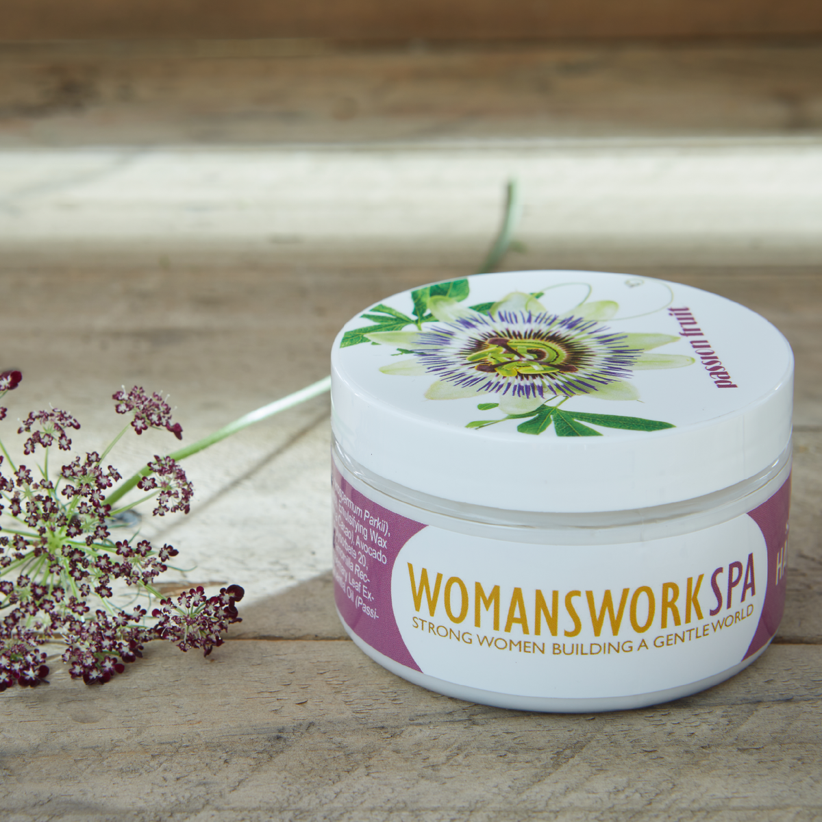 Passion Fruit Shea Butter Hand Cream by Womanswork in a jar with floral lid on rustic wood on Tampa Home & Garden Store
