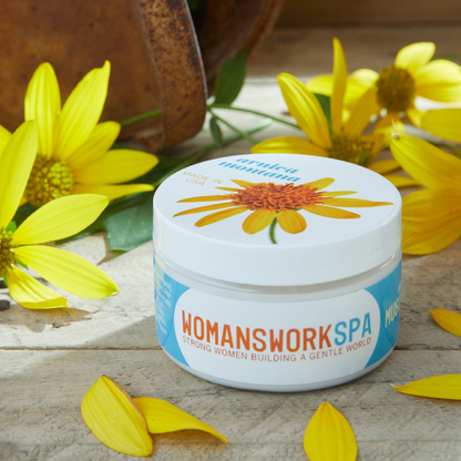 Arnica Shea Butter Muscle Rub jar by Womanswork, white container with sunflower lid on Tampa Home & Garden Store