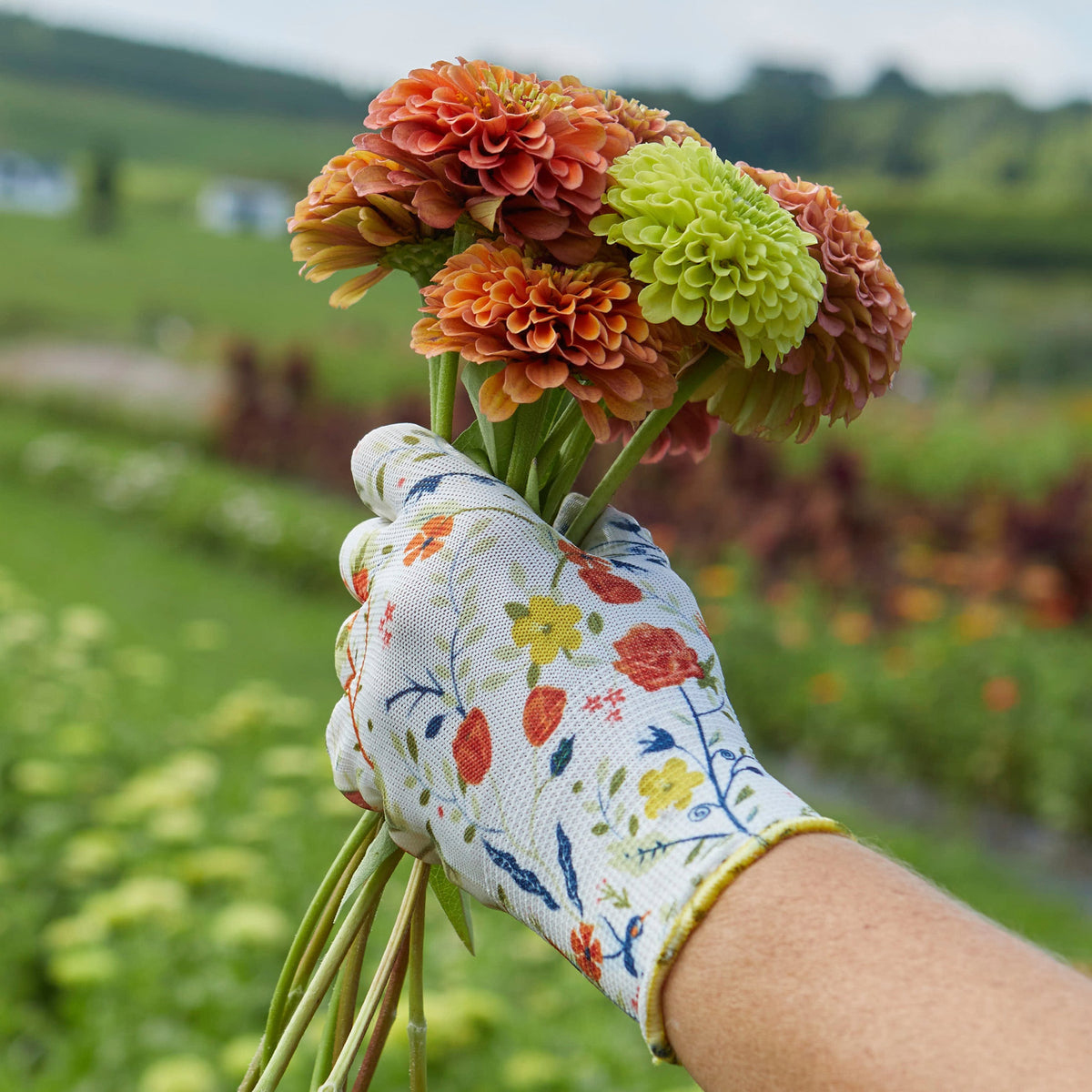 Nitrile Weeder Gloves by Womanswork shown with floral-pattern sleeve in garden on Tampa Home & Garden Store