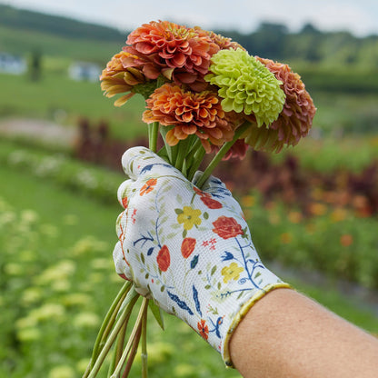 Nitrile Weeder Gloves by Womanswork shown with floral-pattern sleeve in garden on Tampa Home & Garden Store