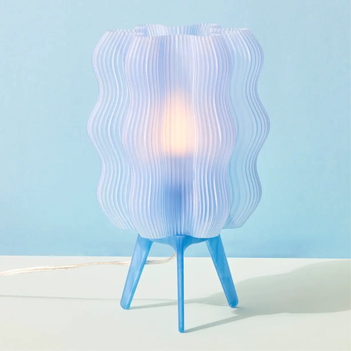 Eco Friendly Wavy Jellyfish Desk Light; blue ribbed shade on a 3-leg blue tripod base, warm glow on Tampa Home & Garden Store