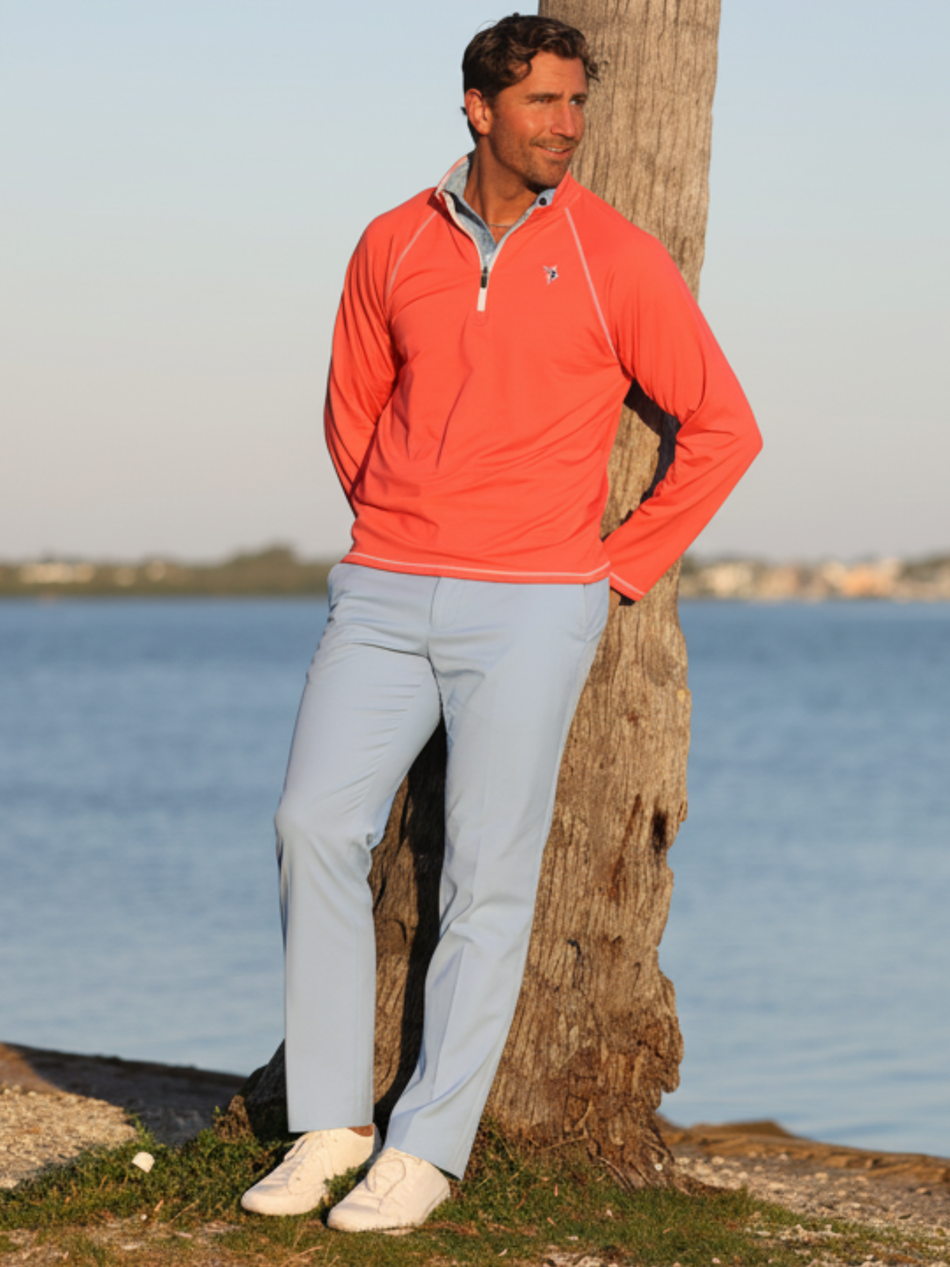 New Harbor Quarter Zip by White Water Life in coral orange with white piping worn by man on Tampa Home & Garden Store