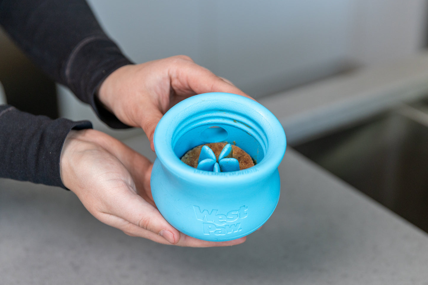 Toppl Treat blue dog treat toy by West Paw with treat inside on Tampa Home & Garden Store