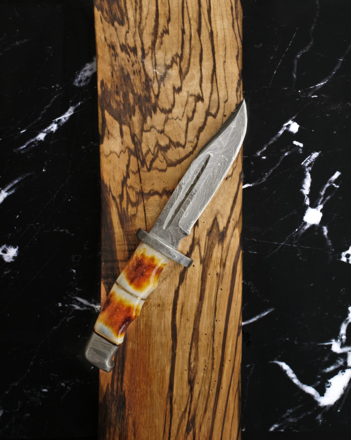 Damascus hunting knife TD-216 amber bone handle on wood board on Tampa Home & Garden Store