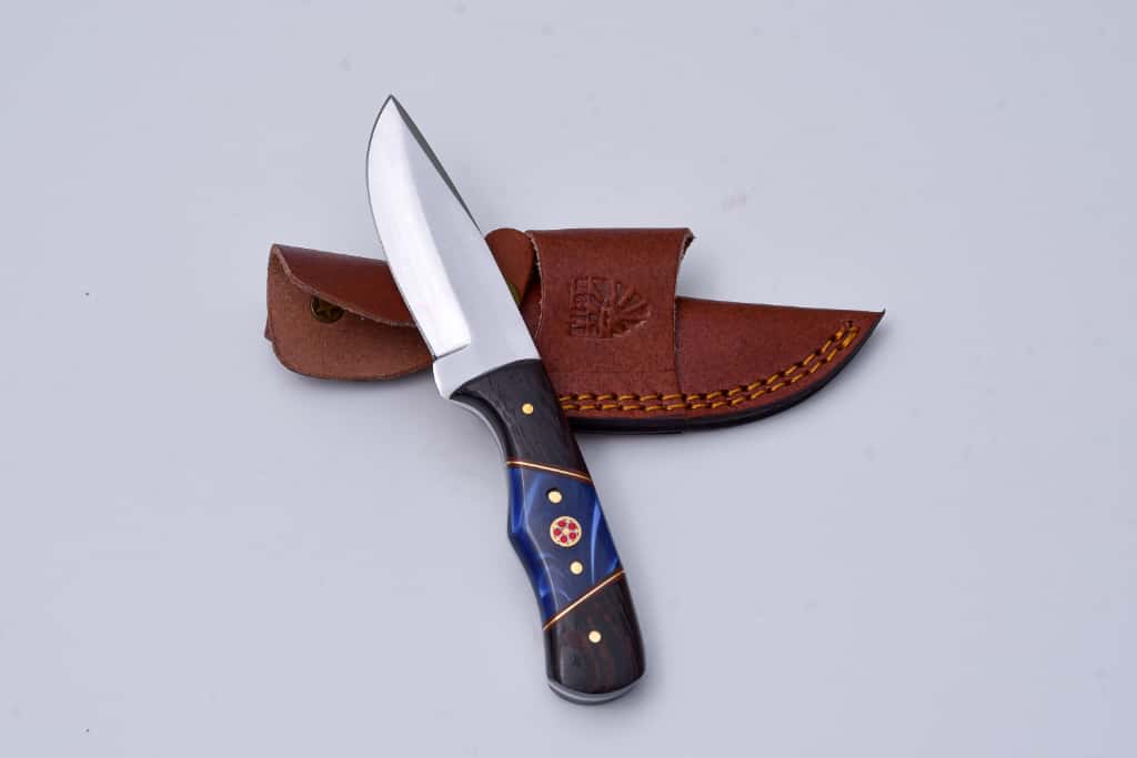 Skinner Knife TS-3 by Titan International K with dark wood and blue inlay handle, leather sheath on Tampa Home & Garden Store