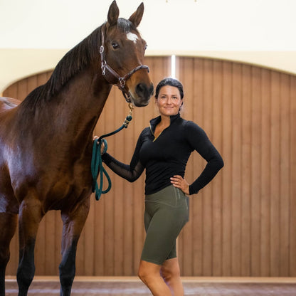 Equestrian Underwear - Knee Length olive green riding shorts by Eques Pante, worn by a rider with a horse indoors on Tampa Home & Garden Store