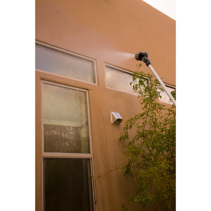 X-Stream 72in Telescoping 4-Pattern Watering Wand Orbit Irrigation spraying orange stucco wall on Tampa Home & Garden Store