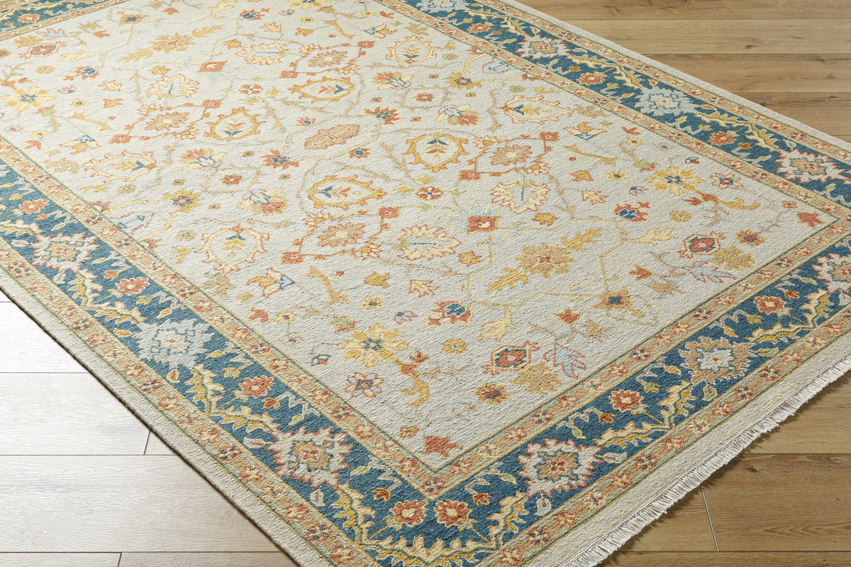 Yenimahalle Rug by Boutique Rugs, ivory field with pastel floral motif and blue border on Tampa Home & Garden Store