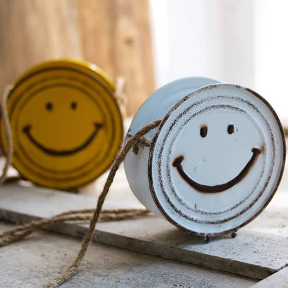 Happy Face Hanging Planters, two white and yellow distressed metal faces with twine on Tampa Home & Garden Store