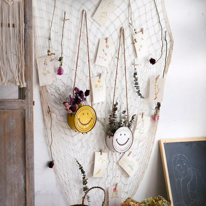 Happy Face Hanging Planters; yellow and white smiley rope-hung planters on a net backdrop on Tampa Home & Garden Store
