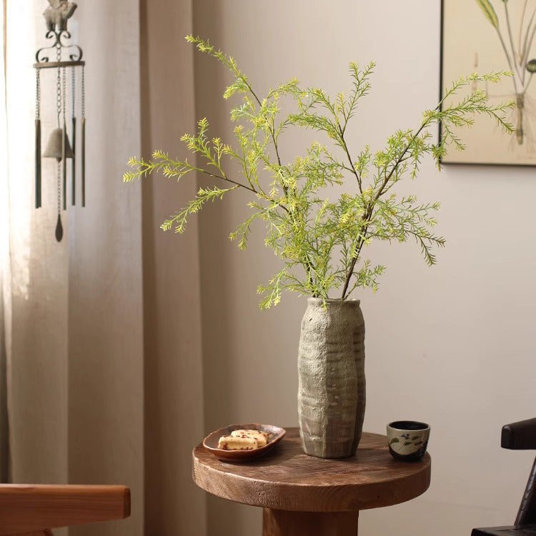 41-inch lifelike layered leaf spray in a gray textured ceramic vase on a round wooden table on Tampa Home & Garden Store