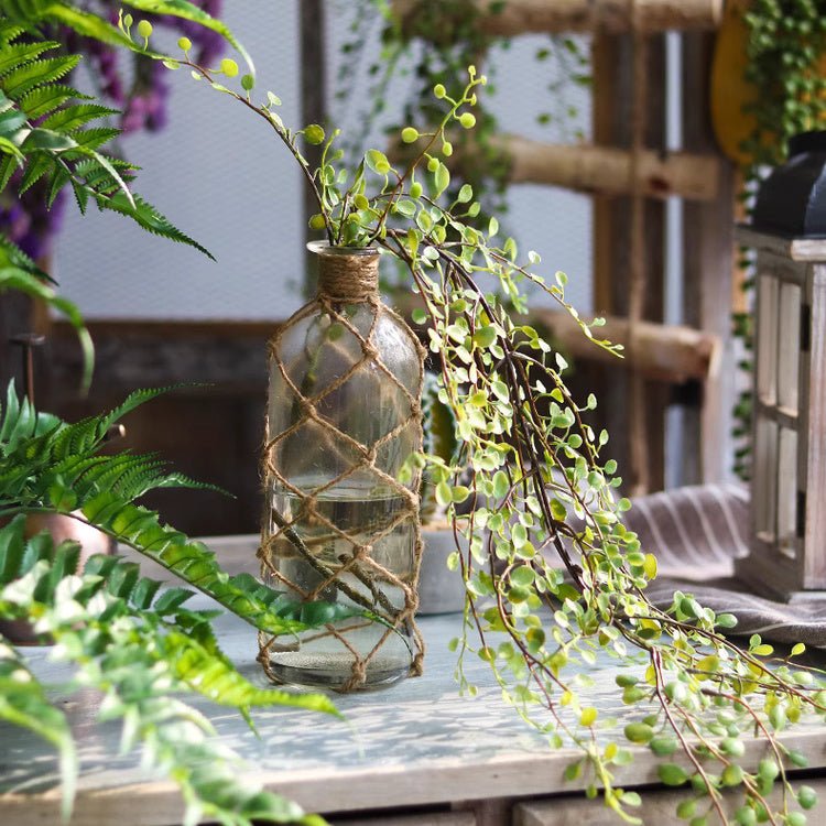 Hanging faux mini leaf garland 27.5 long around a glass bottle vase with twine RusticReach on Tampa Home & Garden Store