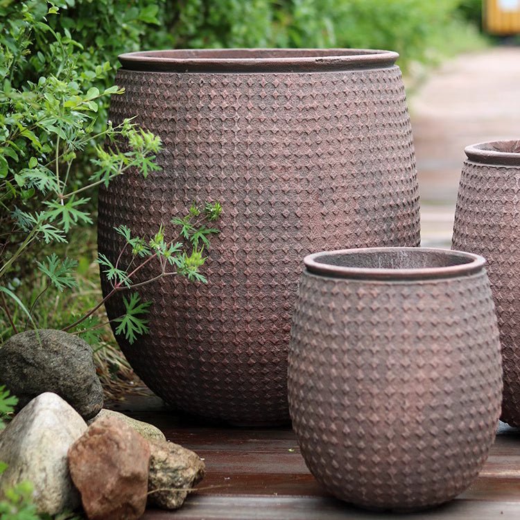 StoneNest Textured Planter by RusticReach; brown, dimpled planters in 3 sizes on a deck on Tampa Home & Garden Store