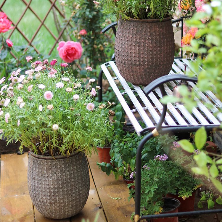 StoneNest Textured Planters, brown woven pots on a deck with flowers, two planters on Tampa Home & Garden Store